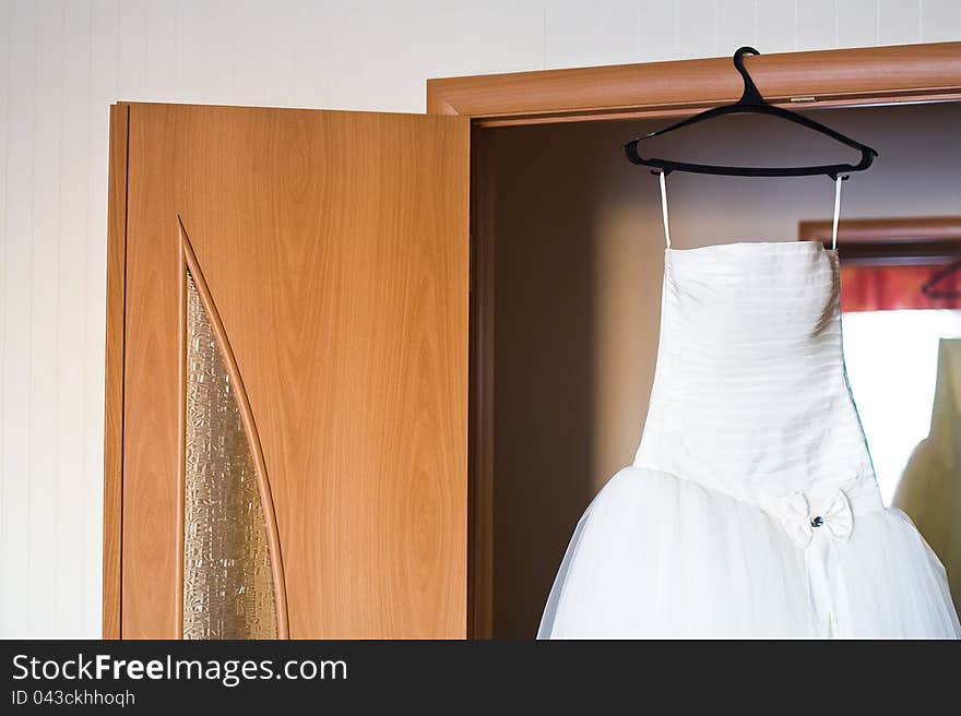 Wedding dress hung up on case