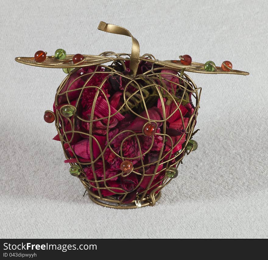 Iron apple with dried flowers and red and green beads. Iron apple with dried flowers and red and green beads