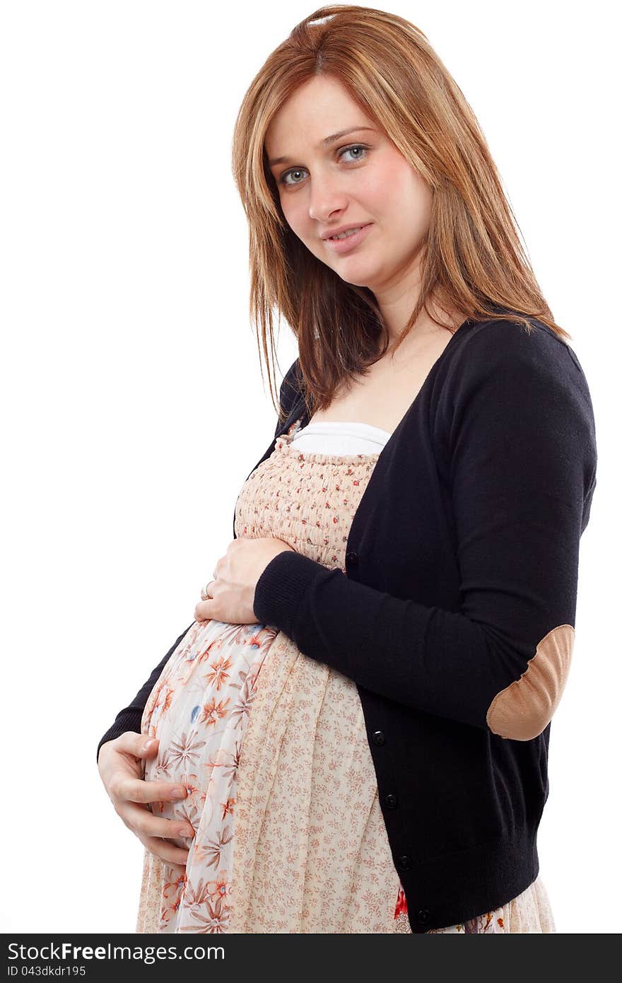 Young pregnant woman smiling and keeping her belly