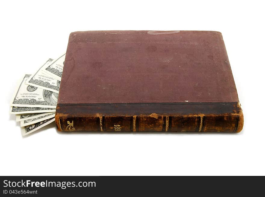 In an old book hidden dollars on white background. In an old book hidden dollars on white background