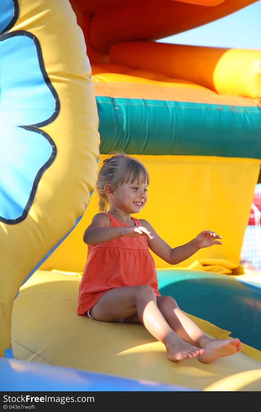 Little Girl Playing On The Trampoline