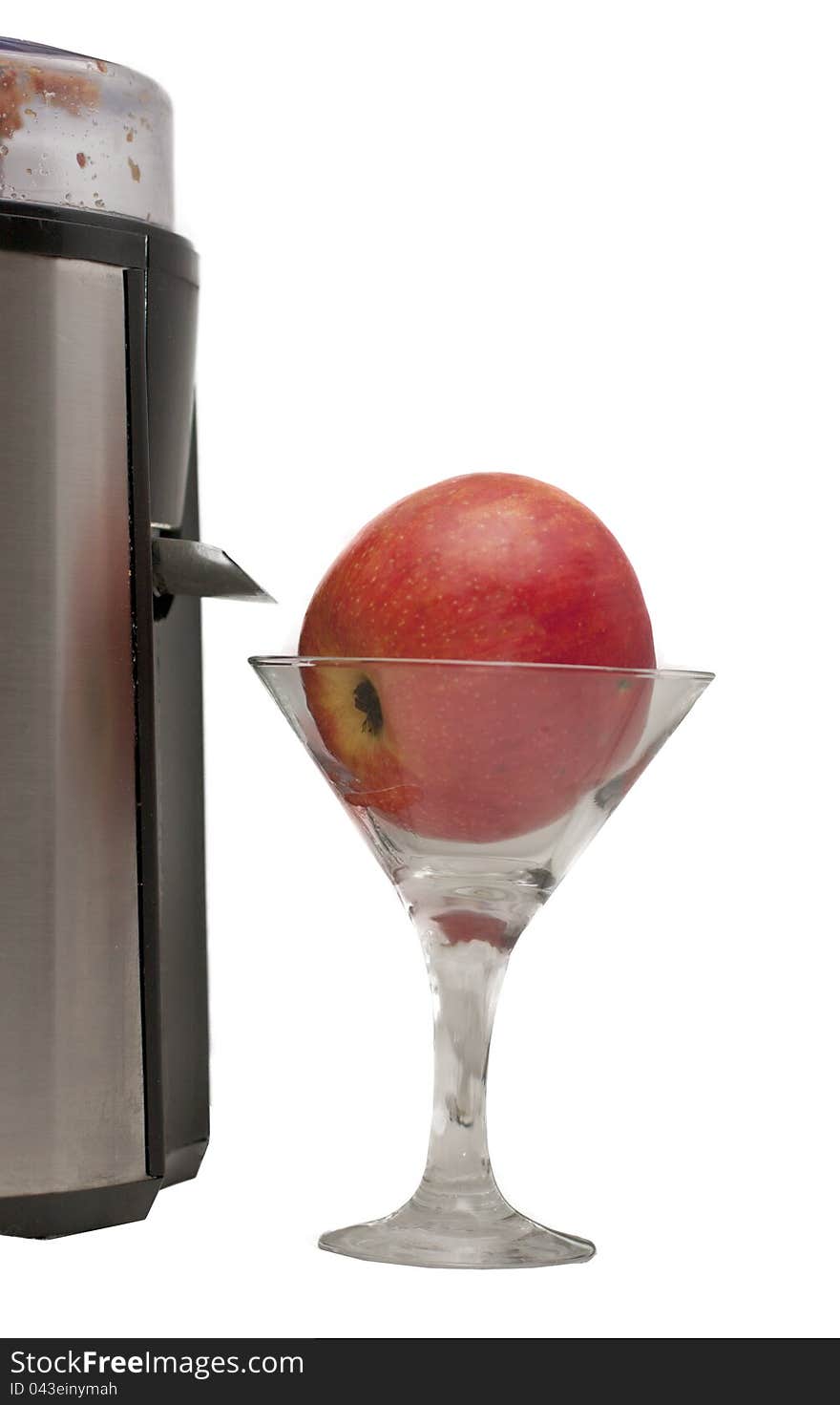 Apple in a glass and a juicer on a white background