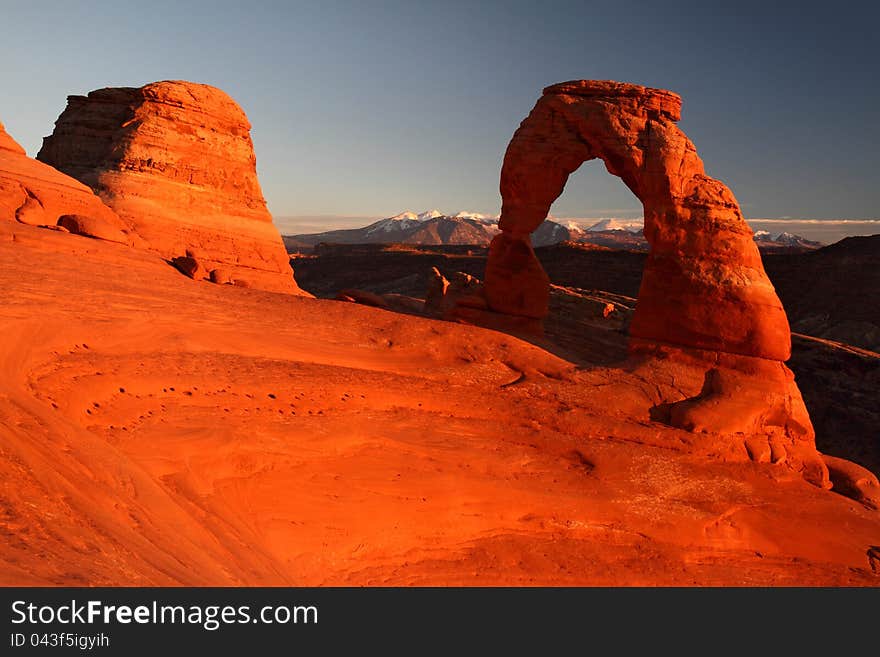 Delicate arch glowing red at sunset in arches national park, utah. Delicate arch glowing red at sunset in arches national park, utah