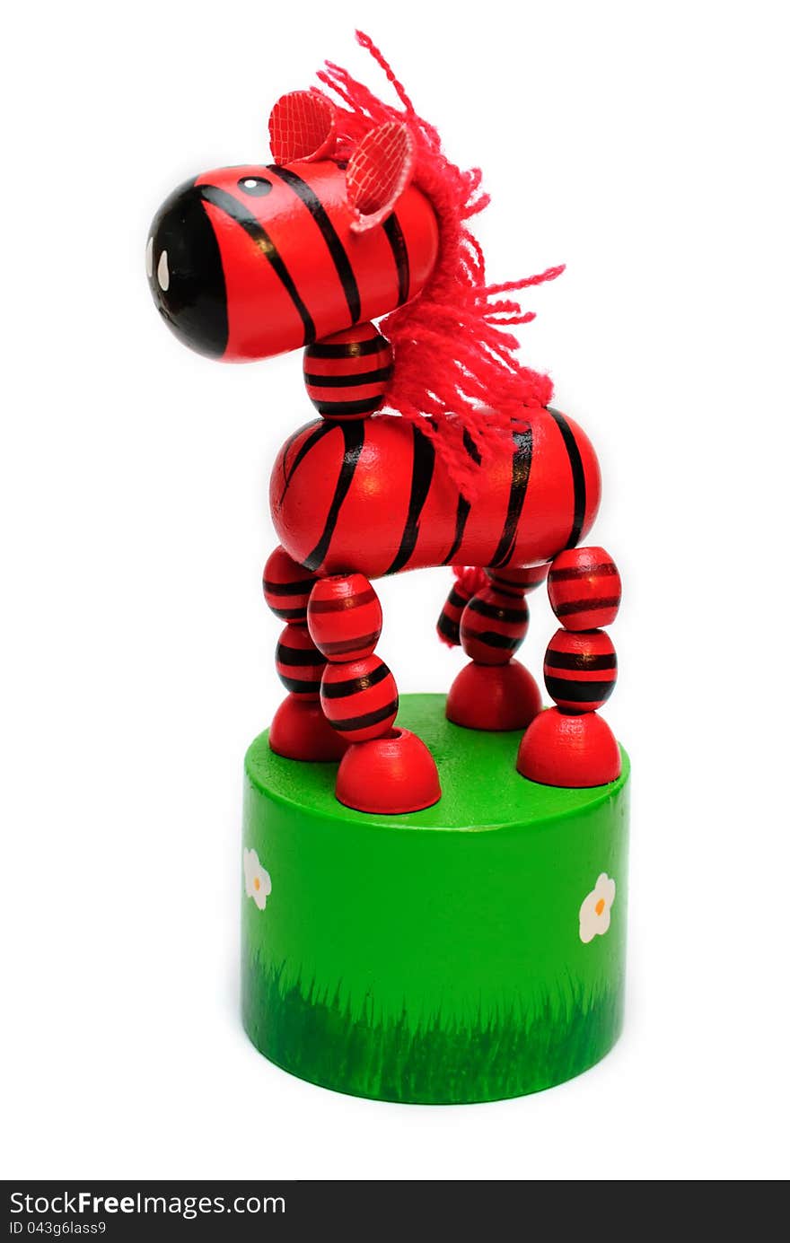 Isolated wooden toy. springy red horse with a fishing line inside. Isolated wooden toy. springy red horse with a fishing line inside