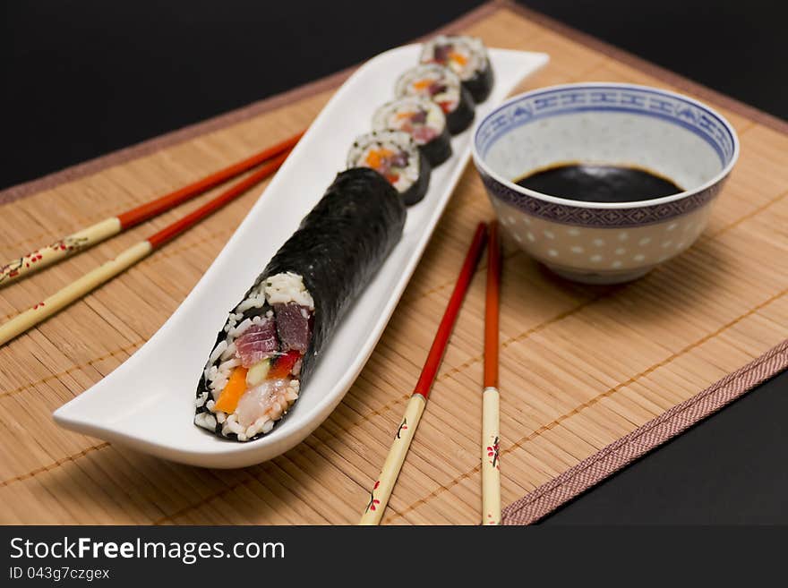 Sushi and soy sauce served with chopsticks