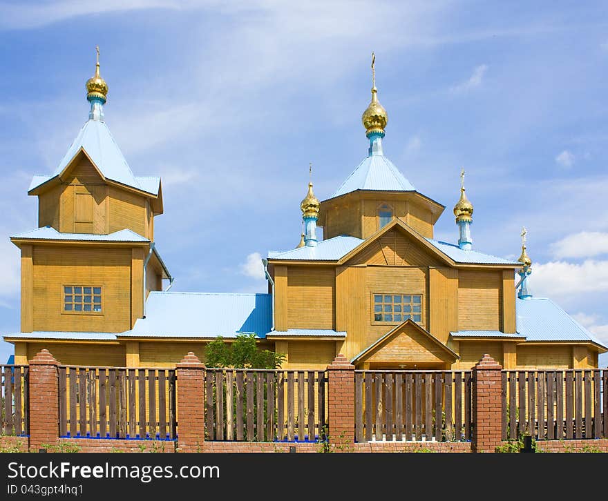 A small rural church in the background of blue sky