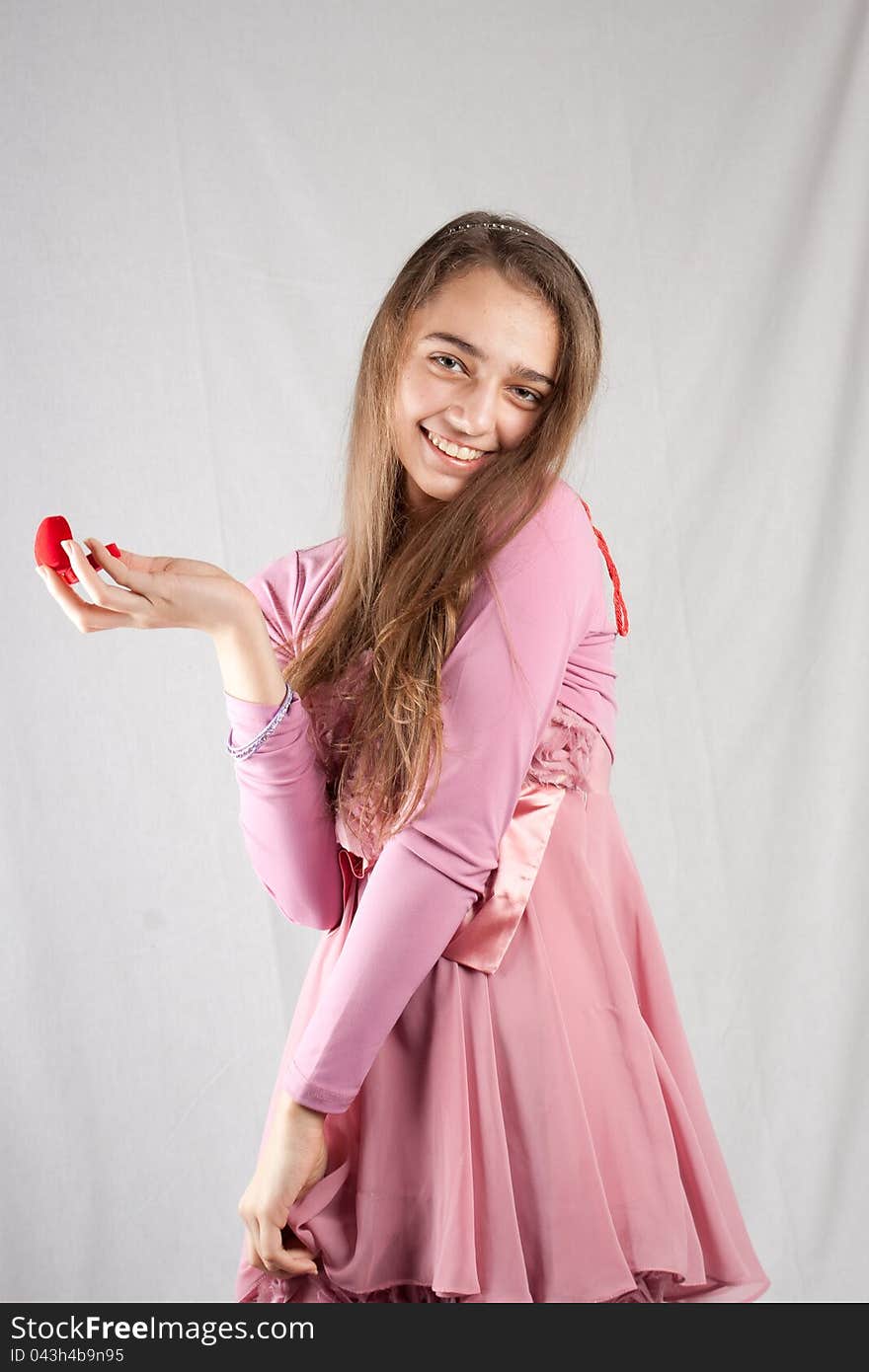 Teenage girl in pink with plush heart