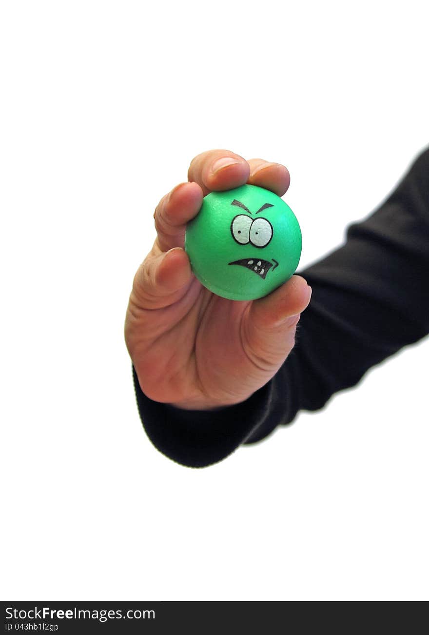 Closeup of a man's hand holding a green unhappy ball over white. Closeup of a man's hand holding a green unhappy ball over white