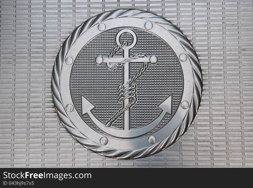 A metallic plate with anchor figure. A metallic plate with anchor figure