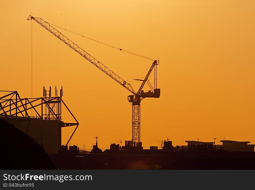 Crane on a sunset background. Building site