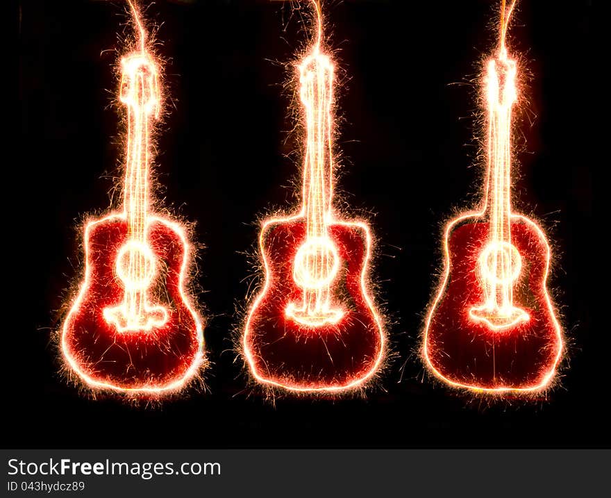 Sparkling guitarr silhouette against a black background. Sparkling guitarr silhouette against a black background