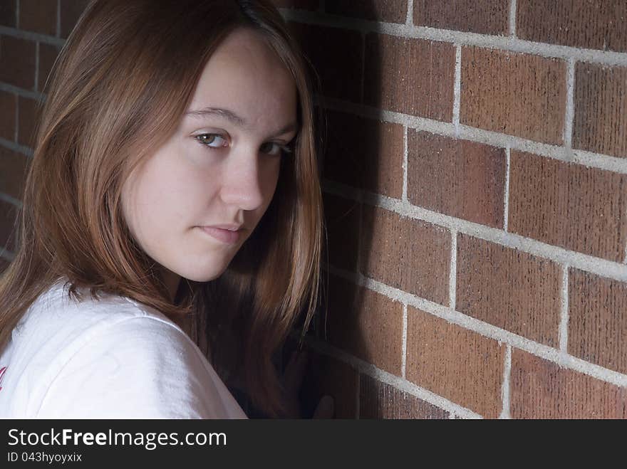 Girl against the wall trying to be sneaky, or cute. Girl against the wall trying to be sneaky, or cute.