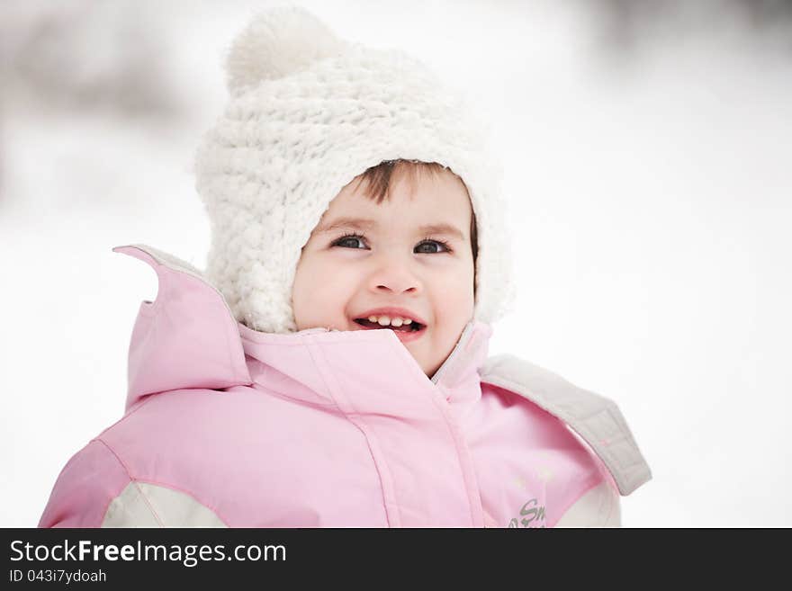 Little girl playing in the snow