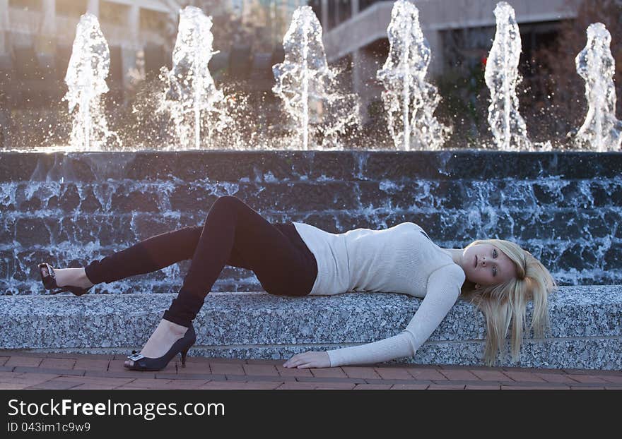 Pretty Young WOman In Front Of Fountain