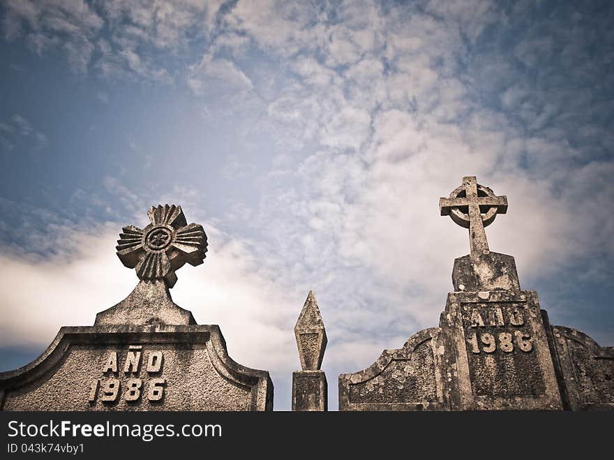 Stone crosses in a Catholic cemetery and sky with clouds. Stone crosses in a Catholic cemetery and sky with clouds