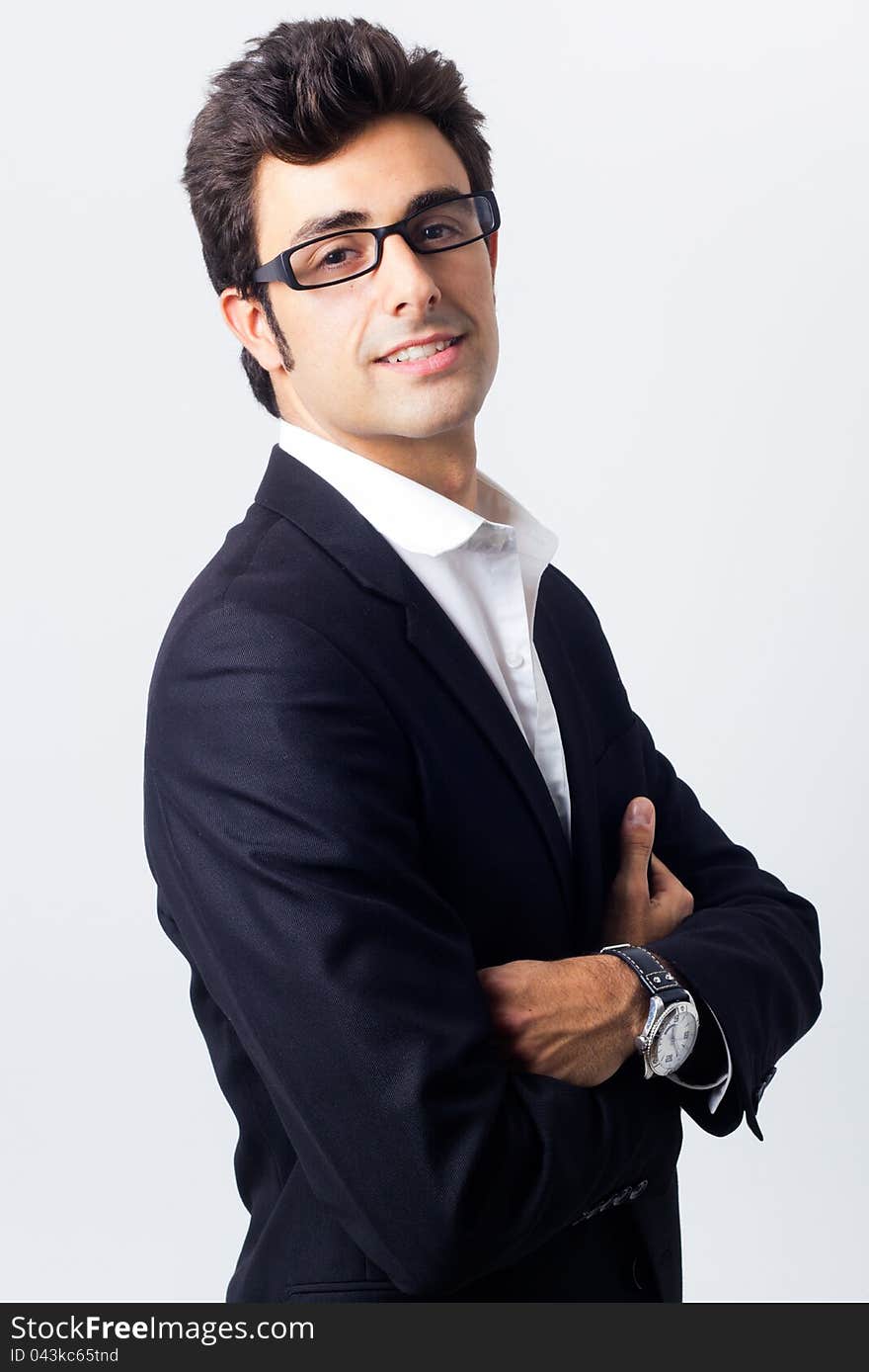 Attractive young businessman posing in front of the camera. Attractive young businessman posing in front of the camera