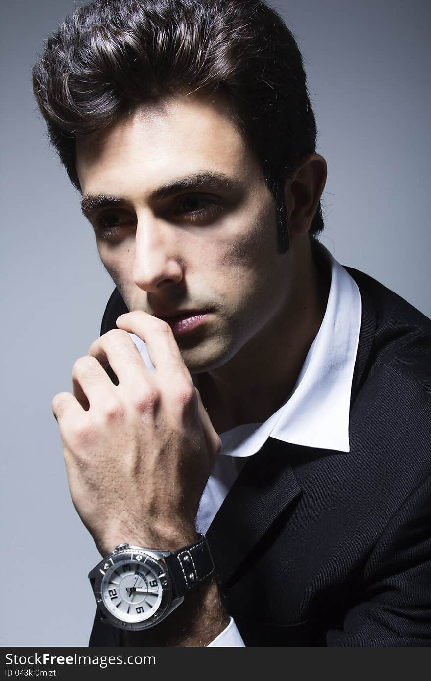 Attractive young businessman posing whit his watch. Attractive young businessman posing whit his watch