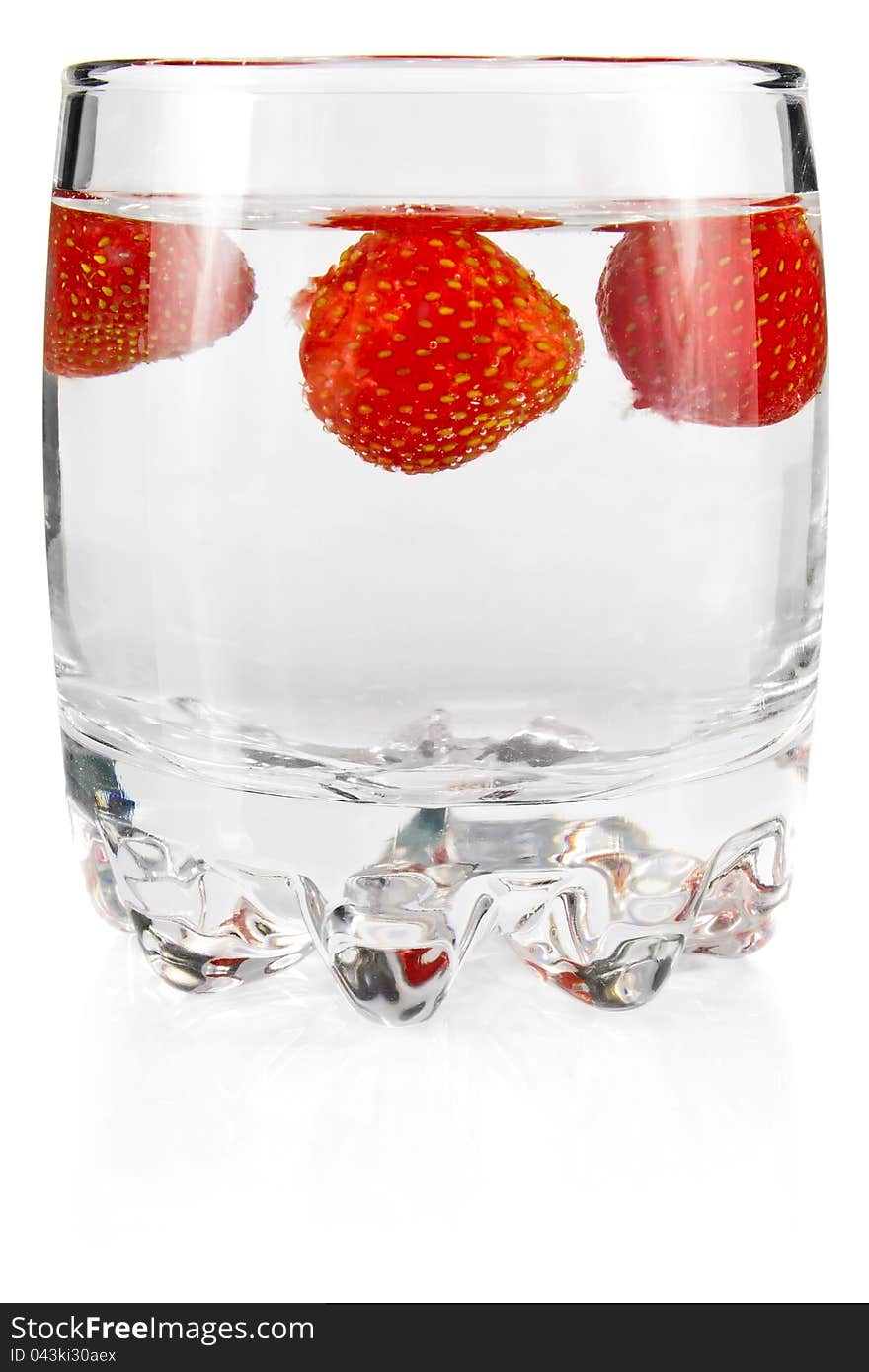 Water in glass with strawberry on white background