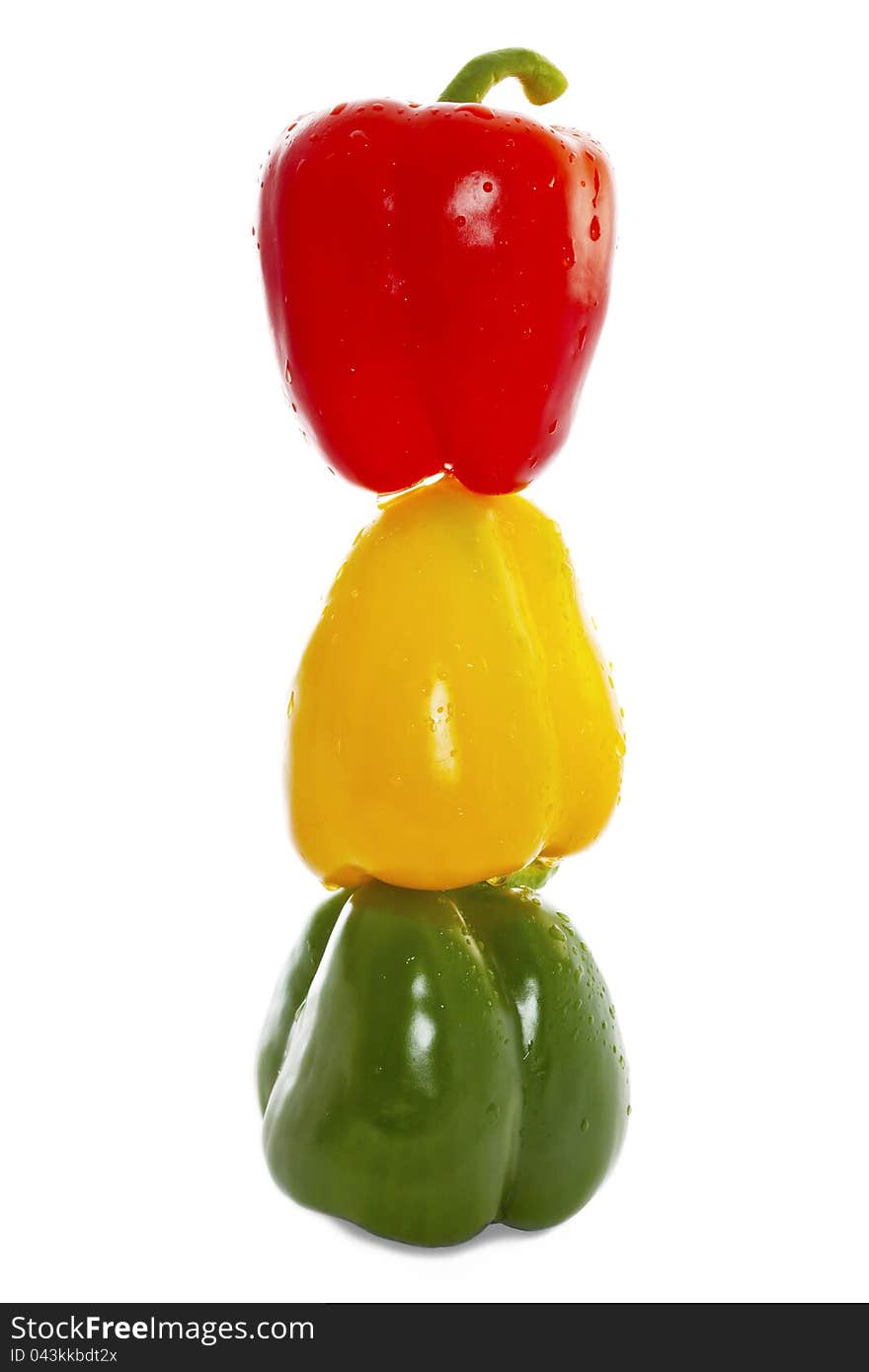 Sprinkled fresh green, yellow and red paprika in upright row.  on White. Sprinkled fresh green, yellow and red paprika in upright row.  on White