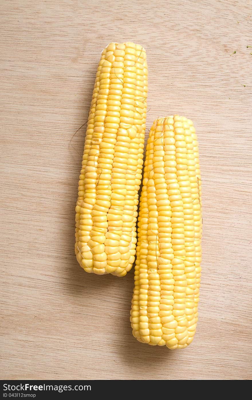 Yellow sweet corn shot over wooden background