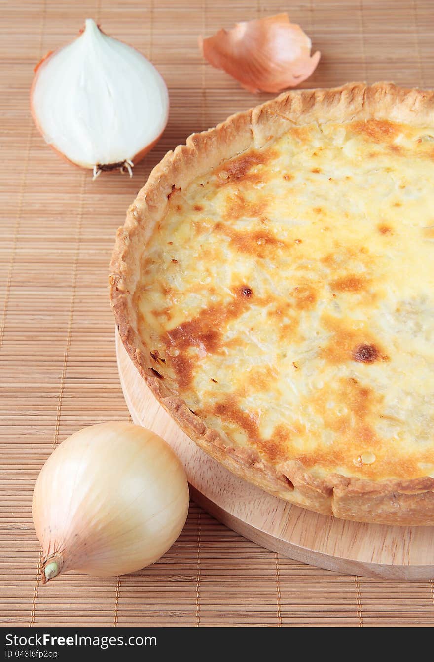 Pie with onions on a wooden board