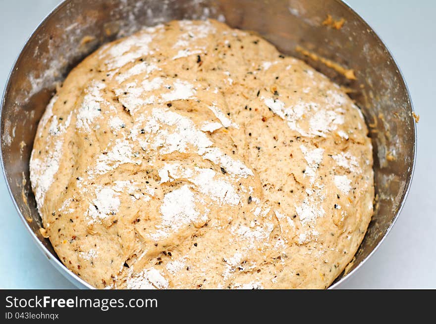 A sweet rye bread dough rising in a bowl. A sweet rye bread dough rising in a bowl.