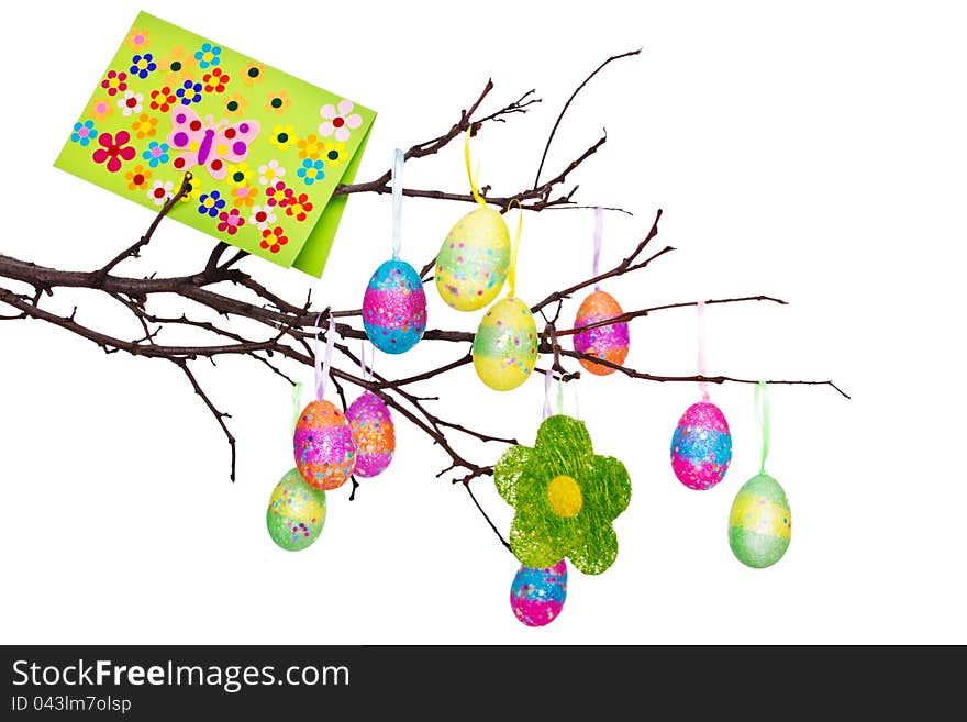 Easter eggs and greeting card hanging on the branch