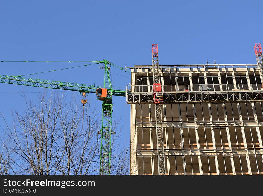 A construction crane with a building