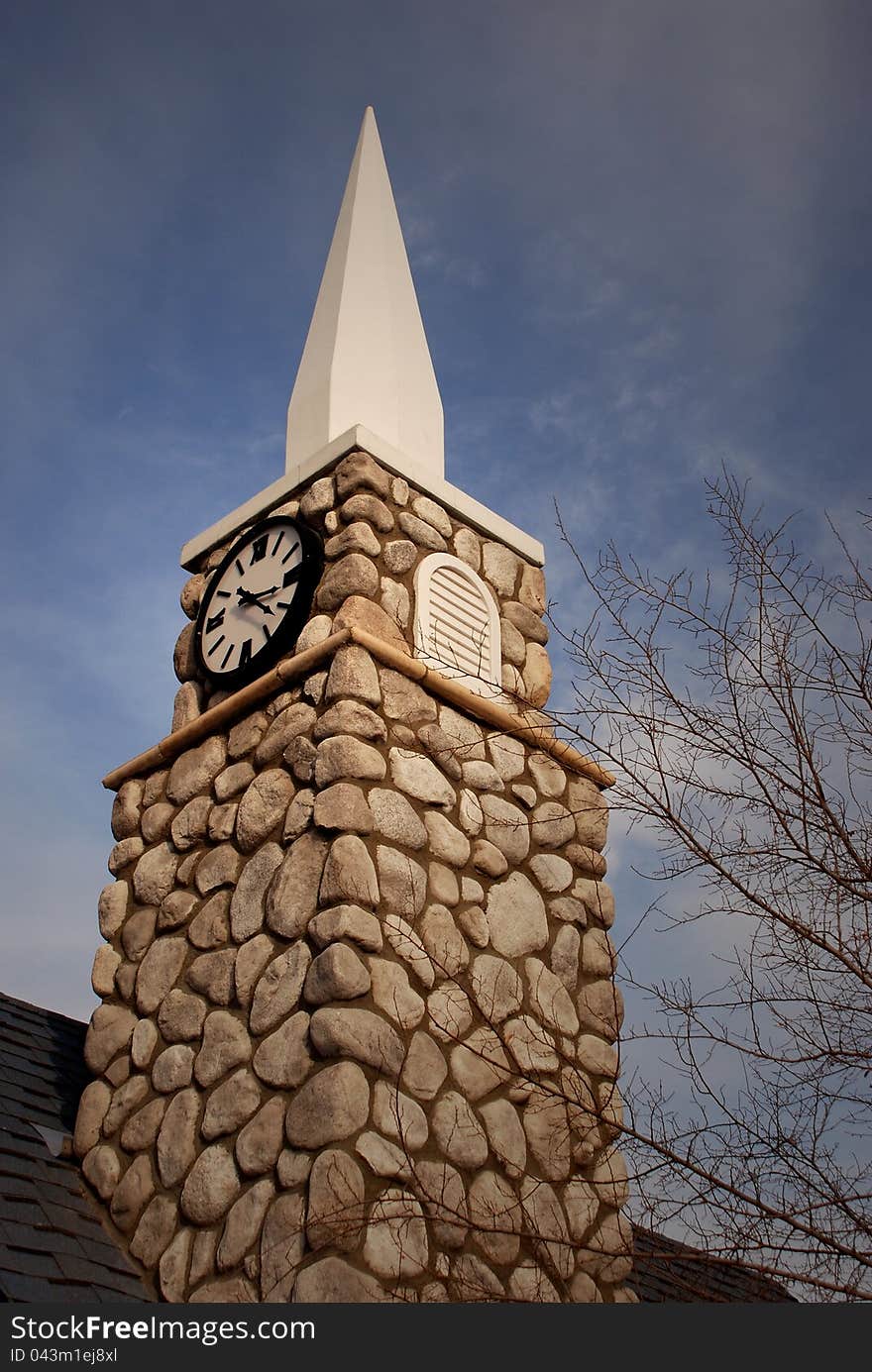 chapel steeple with clock, pointing to the sky. chapel steeple with clock, pointing to the sky.