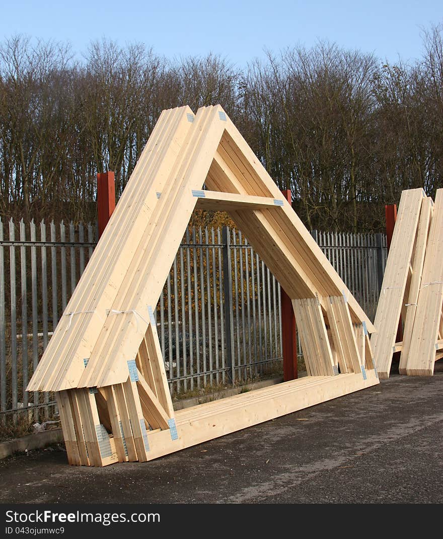 A Stack of Timber Roof Trusses in a Stock Yard.