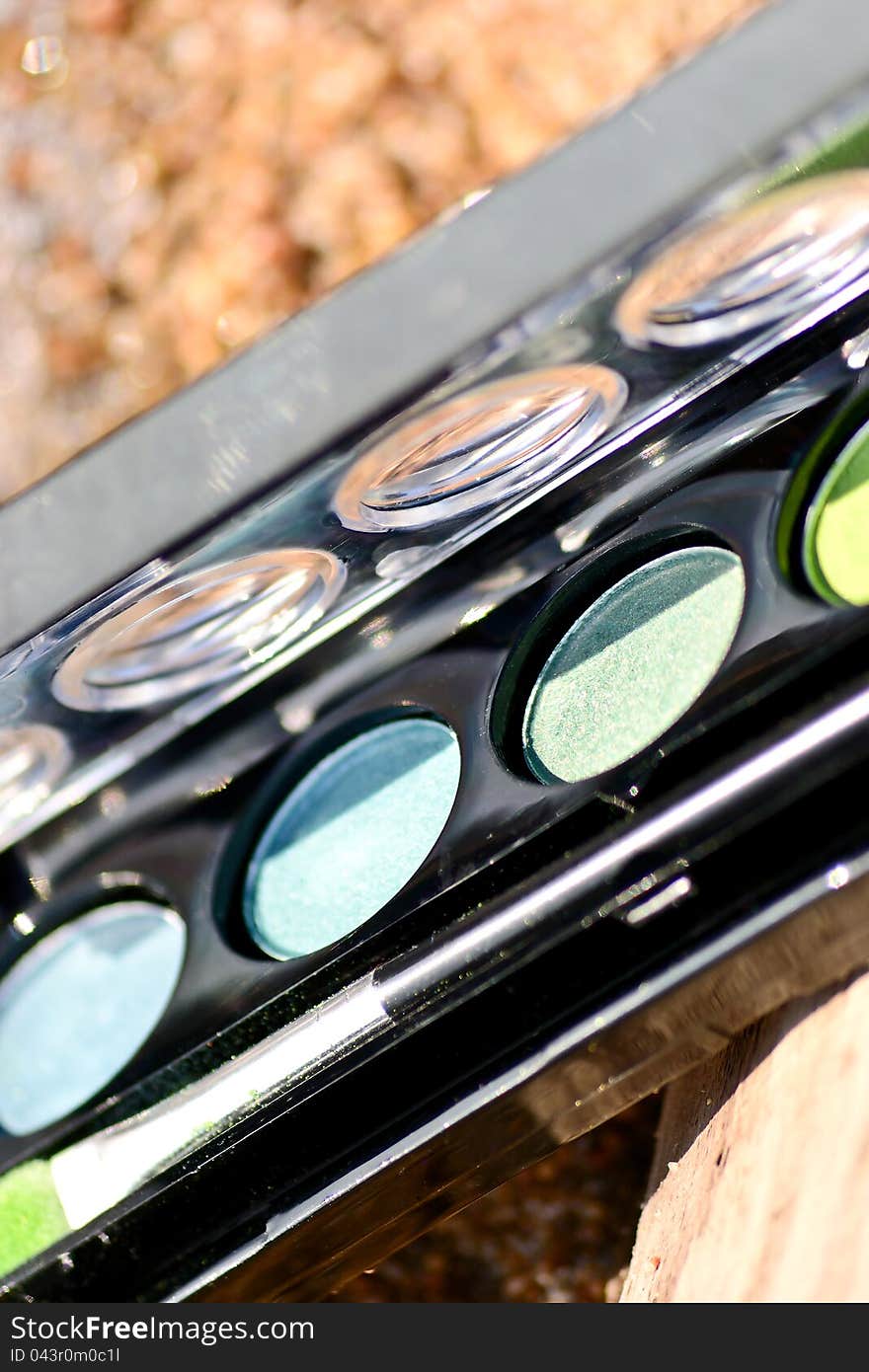 Makeup box by the lake on the sand