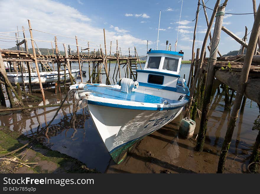 Blue boat in wooden pier