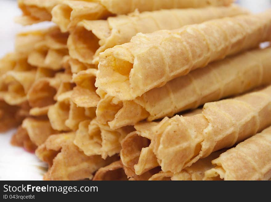 Dessert - sweet yellow wafers on desktop in a plate