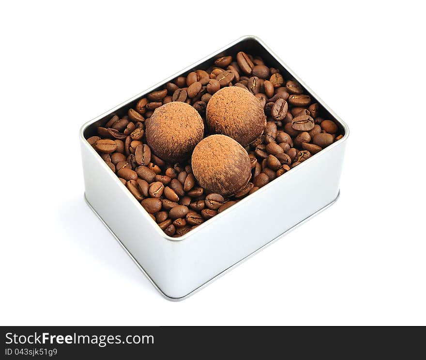 Chocolates, coffee beans in a tin box on a white