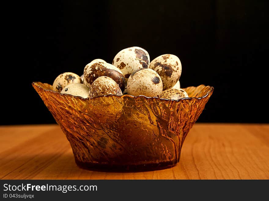 Vase with quail eggs on wooden table. Vase with quail eggs on wooden table.