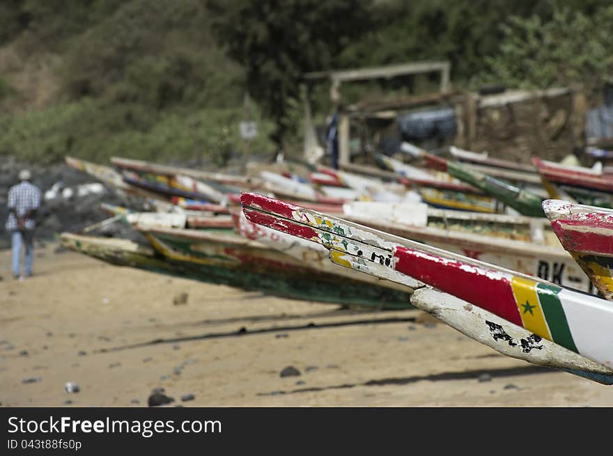 Some colorful fishing dugouts on a beach in Senegal, west Africa. Some colorful fishing dugouts on a beach in Senegal, west Africa.