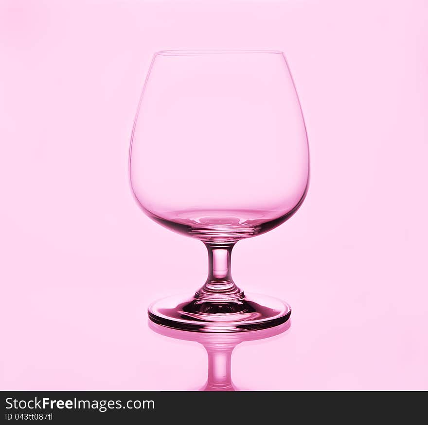 Brandy glass on pink background