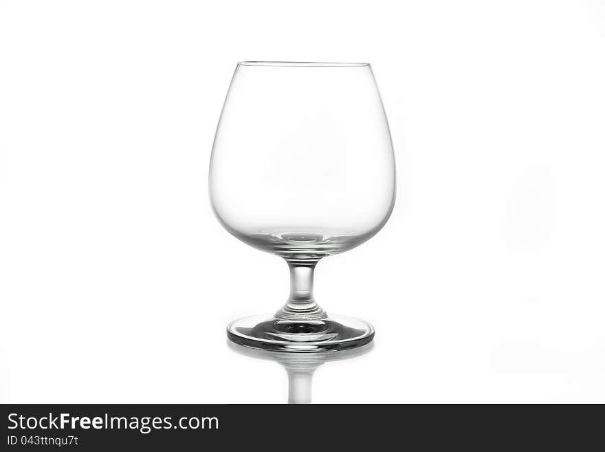 Empty brandy glass on white background