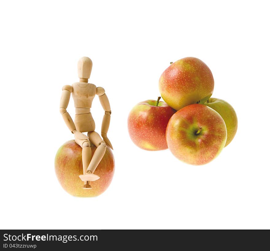 Wooden model sits on an apple