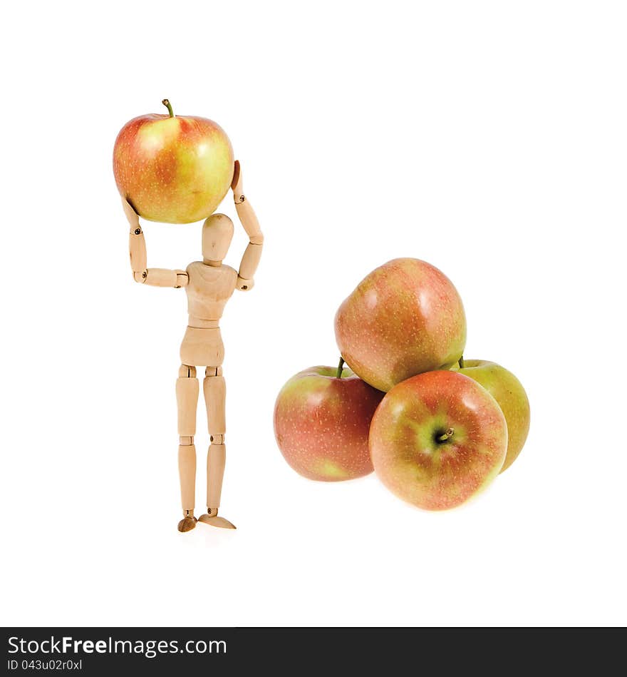 Wooden model holds an apple near the heap