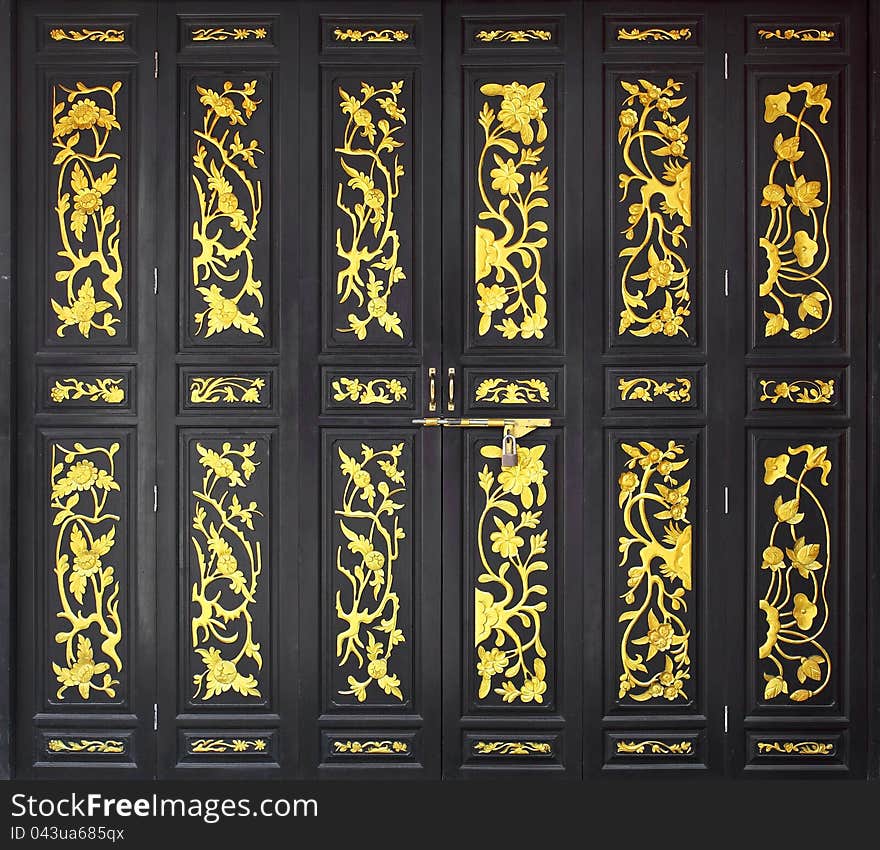 Flower carved gold paint on vintage wood door. Flower carved gold paint on vintage wood door