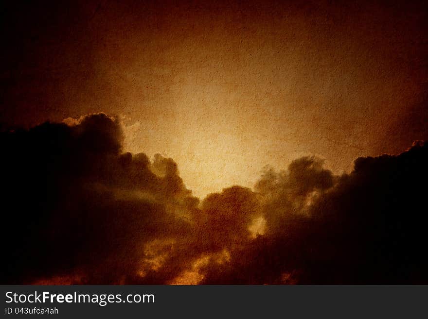 Dramatic background - dark sky, bright sun on textured paper