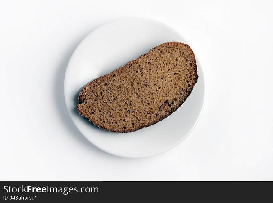 Slice of bread on a white plate on a white background