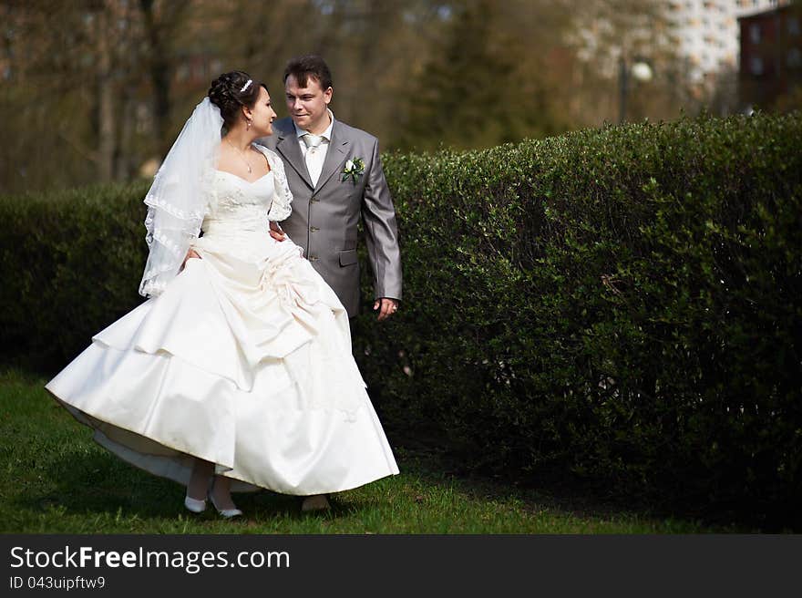 Happy bride and groom walking