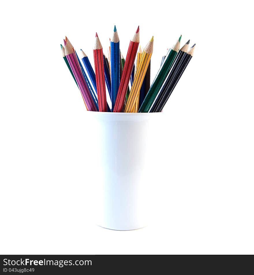 High-key, back lit image of colored crayon pencils in a white container. Copy space. High-key, back lit image of colored crayon pencils in a white container. Copy space.