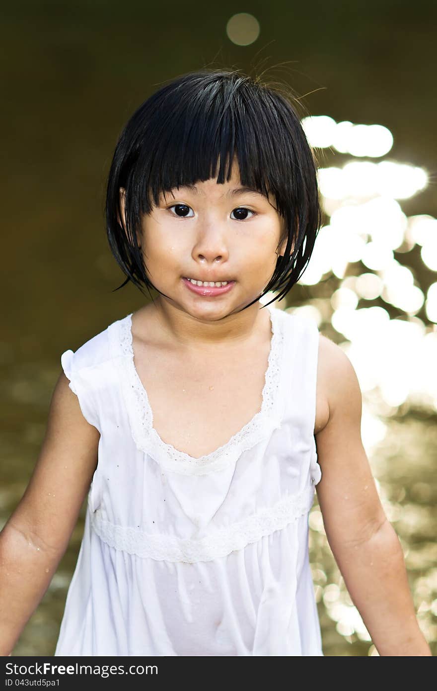 Little Asian Girl wearing wet dress