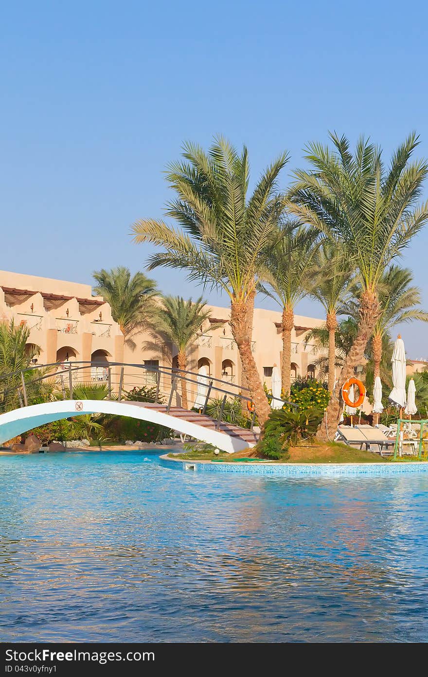 African resort with luxury swimming pool and bridge (Hurghada, Egypt). Vertically.