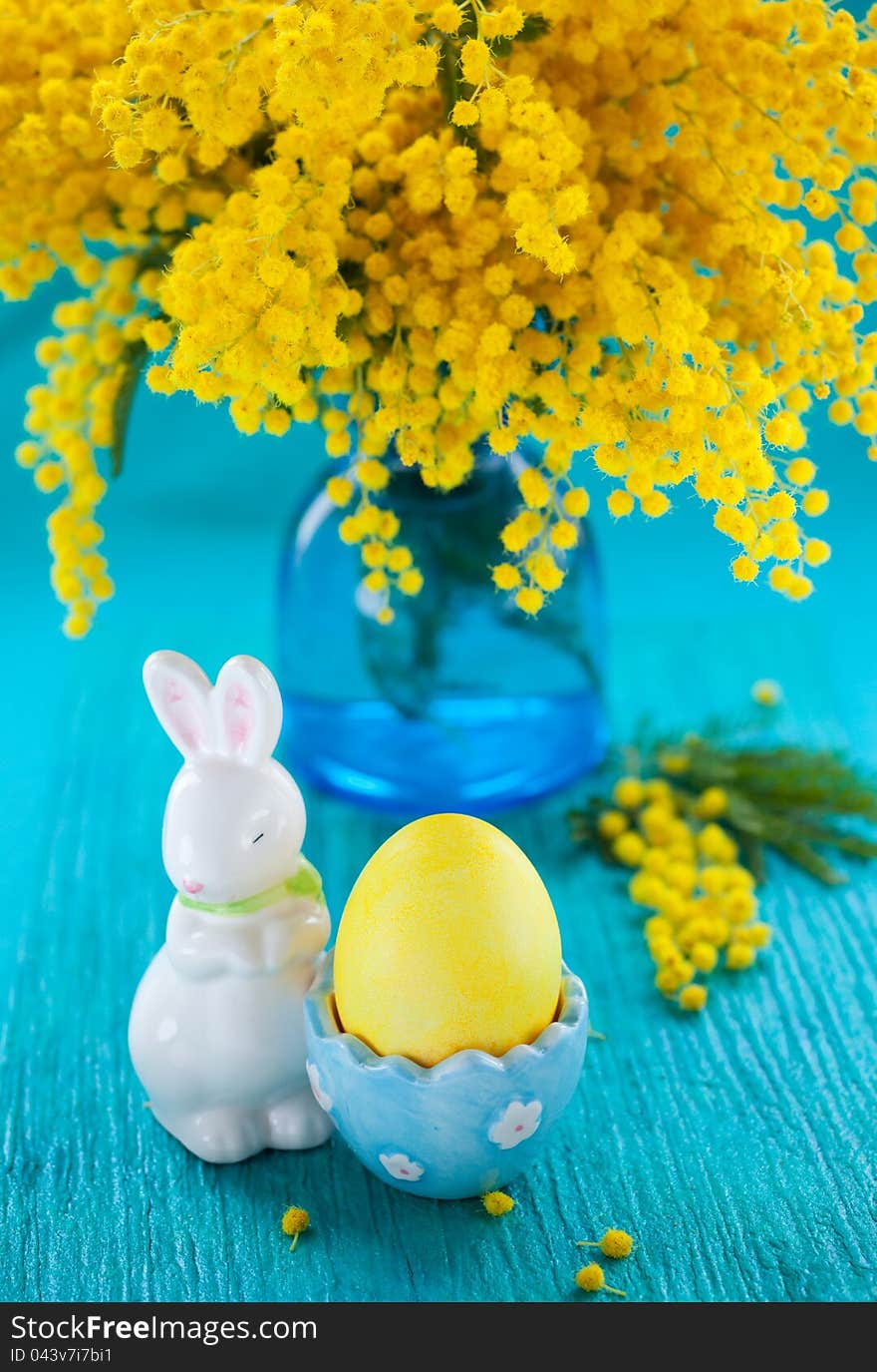 Easter decoration with yellow mimosa and egg