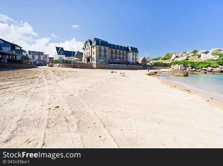 Urban sand beach in breton town Perros-Guirec in summer day, France