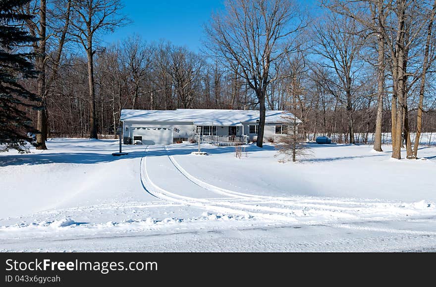 A small family home covered by snow. A small family home covered by snow.